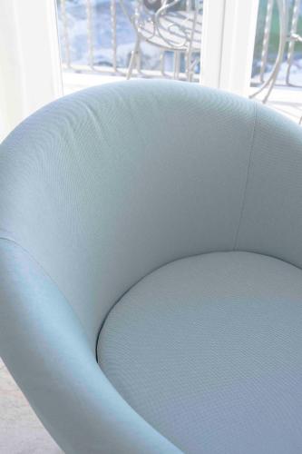 a blue chair in a room with a balcony at Albergo La Prora in Capri
