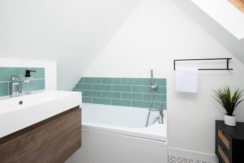 a bathroom with a tub and a sink at Large 5 Bedroom House - Alnwick in Alnwick