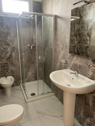 a bathroom with a shower and a sink and a toilet at Camere Lorenzo in Porto Cesareo