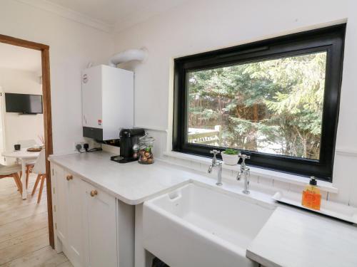 a kitchen with a sink and a window at West Island in Kingsbridge