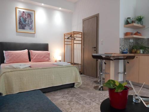 a bedroom with a bed and a table and a desk at Nisos suite in Ermoupoli