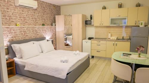 a small bedroom with a bed and a kitchen at Bliss Apartments with free parking in Split