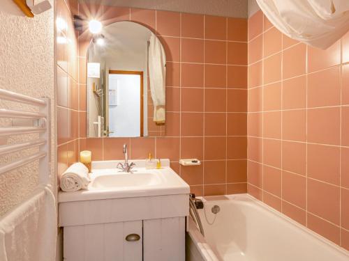 a bathroom with a sink and a tub and a mirror at Appartement Val-d'Isère, 3 pièces, 6 personnes - FR-1-694-19 in Val-d'Isère