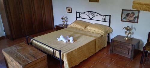 a bedroom with a bed with two candles on it at Villa Bruno in Pisticci