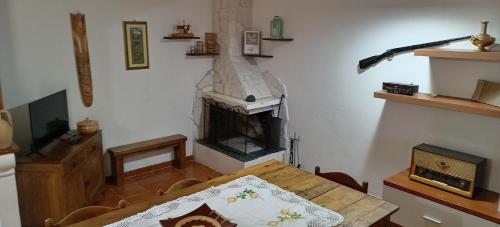 a living room with a table and a fireplace at Villa Bruno in Pisticci