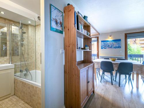 a bathroom with a shower and a dining room with a table at Appartement Val-d'Isère, 4 pièces, 6 personnes - FR-1-694-235 in Val-d'Isère