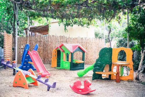 a playground with many different types of play equipment at XeniCamp & Bungalows in Tolo
