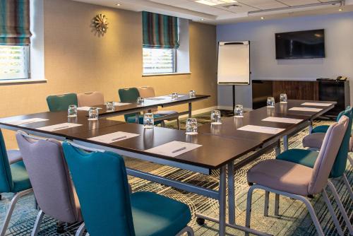 a conference room with a long table and chairs at Ramada Hotel & Suites by Wyndham Coventry in Coventry