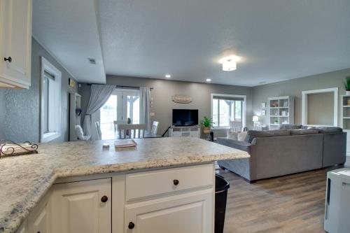 an open kitchen and living room with a couch at Waterfront Home Near Mark Twain National Forest in Poplar Bluff
