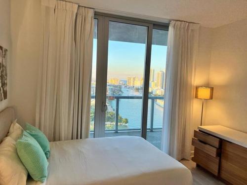 a bedroom with a bed and a large window at Miami Intercoastal Beach Studio Apmt 2QB 1B in Hallandale Beach