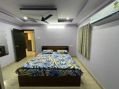 a bedroom with a bed and a ceiling fan at Servostay Furnished 3 BHK in Prime Location Near Arilova - 3rd Floor in Visakhapatnam