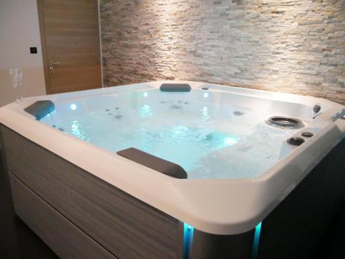 a jacuzzi tub with lights in a bathroom at Gîte Il était une fois in Bourgbarré