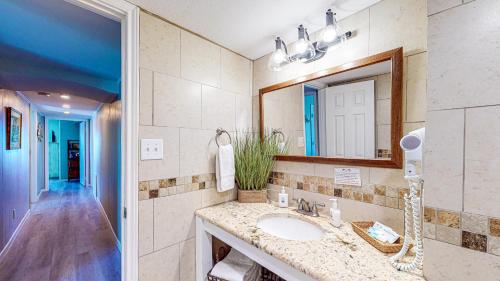 a bathroom with a sink and a mirror at IR104 3BR Condo w Gulf View, Shared Pools, Boardwalk in Port Aransas