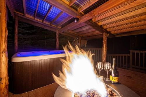 a white bird standing on a table with wine glasses at Corlieu Falls Cabin in Sugar Pine 8 miles from Yosemite with Gazebo, Hot tub a shack and Bar top in Oakhurst