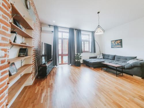 a living room with a couch and a fireplace at Priestranný apartmán v centre in Košice