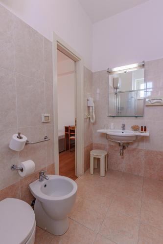 a bathroom with a toilet and a sink at Hotel Tritone in Senigallia