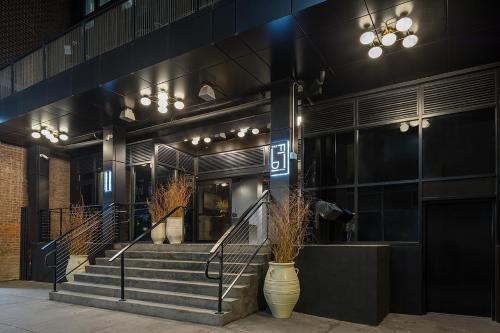 a building with a staircase in front of a store at The FIDI Hotel in New York