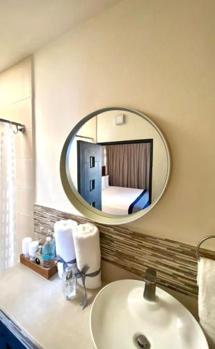 a bathroom with a white sink and a mirror at Arawi Hotel Boutique in Valle de Bravo
