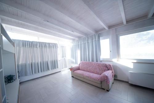 a living room with a chair and a window at 10 e Lode in Mazara del Vallo