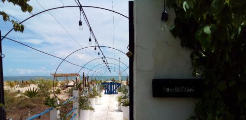 an open door to a path with a view of the ocean at Cytyz Appart Hôtel in Mahajanga