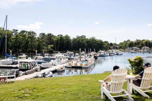 two people sitting in lawn chairs at a marina at Yachtsman Lodge & Marina in Kennebunkport