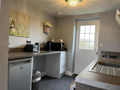 a kitchen with a sink and a counter top at The Coquet Apartment - short stroll to Warkworth Castle and Hermitage in Warkworth