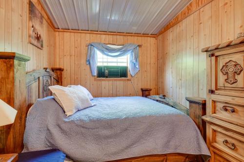 a bedroom with a bed in a room with a window at Crowell Cabin about 9 Mi to Copper Breaks State Park! 