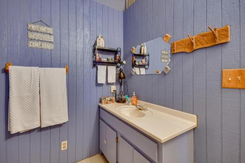a bathroom with a sink and a blue wall at Crowell Cabin about 9 Mi to Copper Breaks State Park! 