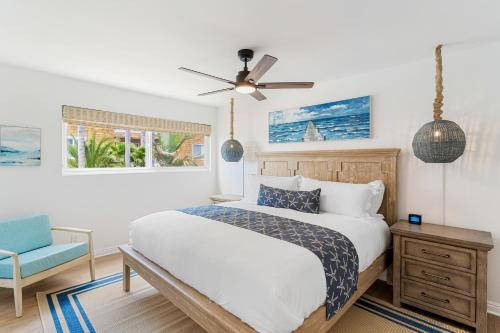 a bedroom with a bed and a ceiling fan at Palm Tree Oasis in Newport Beach