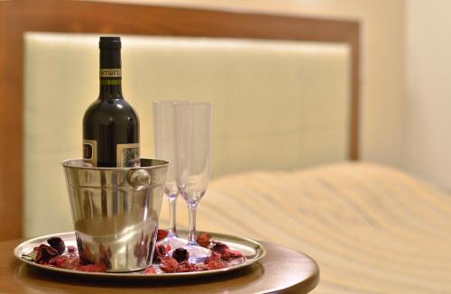 a bottle of wine and glasses on a table at Filoxenia Hotel in Ioannina