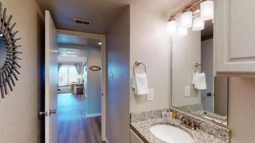 a bathroom with a sink and a mirror at IR145 2nd Floor Condo, Ocean View, 1 Bedroom, Shared Pools, Boardwalks in Port Aransas