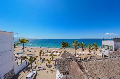 a view of a beach with palm trees and the ocean at Hotel Suites Nadia Puerto Vallarta in Puerto Vallarta