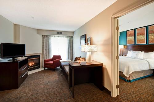 a hotel room with a bed and a television at Residence Inn by Marriott Dayton Beavercreek in Beavercreek