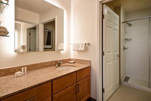 a bathroom with a sink and a mirror at Residence Inn by Marriott Dayton Beavercreek in Beavercreek