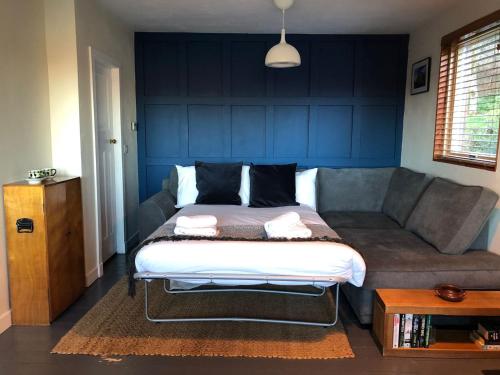 a bedroom with a bed and a couch at Old Kyle Farm - Stunning Views - 2 mins from Skye Bridge in Kyleakin