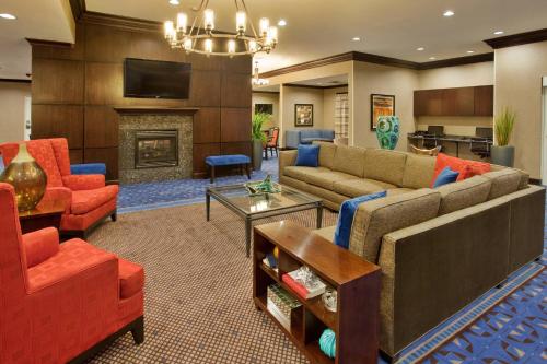 a living room with couches and a fireplace at Residence Inn Odessa in Odessa