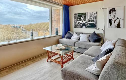 a living room with a couch and a table at Duinennest in Bergen aan Zee