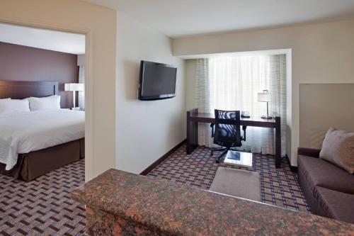 a hotel room with a bed and a couch at Residence Inn Odessa in Odessa