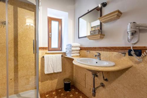 a bathroom with a sink and a shower at Duomo Apartments Cefalù in Cefalù