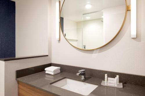 a bathroom with a sink and a mirror at Fairfield Inn & Suites by Marriott Boston Walpole in Walpole