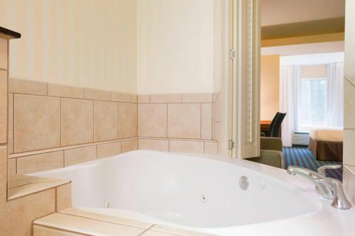 a large white bath tub in a room at Fairfield Inn & Suites Columbia Northeast in Columbia