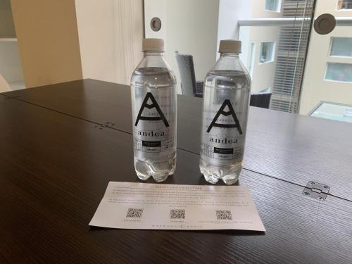 two bottles of water sitting on top of a table at Las Mimosas by Wynwood House in Lima