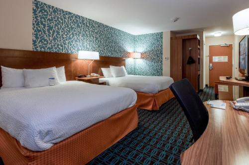 a hotel room with two beds and a desk at Fairfield Inn & Suites by Marriott Montgomery Airport in Hope Hull