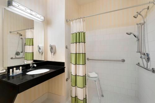 a bathroom with a sink and a shower at Fairfield Inn & Suites by Marriott Champaign in Champaign