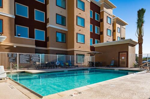 a swimming pool in front of a apartment building at Residence Inn Las Vegas South/Henderson in Las Vegas