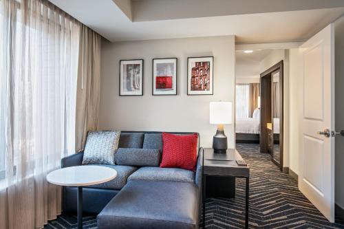 a living room with a couch and a table at Residence Inn by Marriott Boston Cambridge in Cambridge