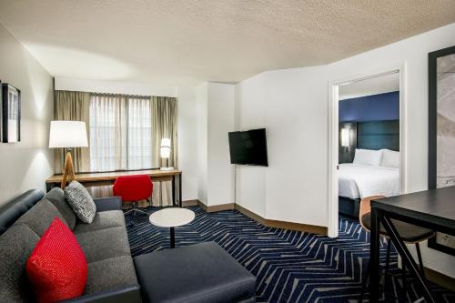 a hotel room with a couch and a bed at Residence Inn by Marriott Boston Cambridge in Cambridge
