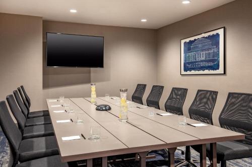 a conference room with a long table and chairs at Residence Inn by Marriott Boston Cambridge in Cambridge