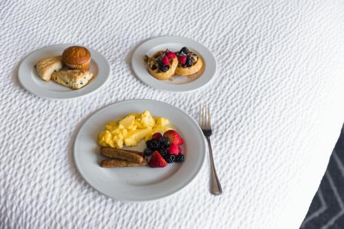 a table with three plates of breakfast food on it at Residence Inn by Marriott Boston Cambridge in Cambridge