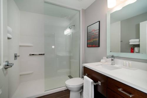 a bathroom with a shower and a toilet and a sink at TownePlace Suites Fort Worth University Area/Medical Center in Fort Worth